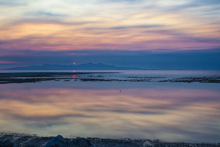 Sunset on the beach with reflection in the water. Beautiful natural background.の写真素材