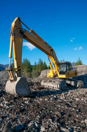 Excavator in a mountainous area in an industrial area in a working pauseの写真素材