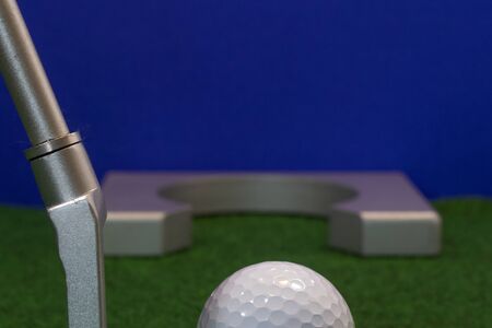 Putter, golf ball and destination for the relaxed office lifeの写真素材