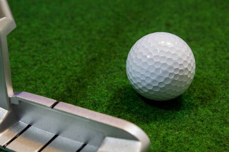 Putter, golf ball and green for the relaxed office lifeの写真素材