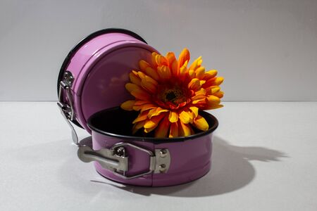material flower of a chrysanthemum on a children's baking dish