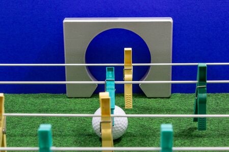clothespins lined up in the form of a football kicker