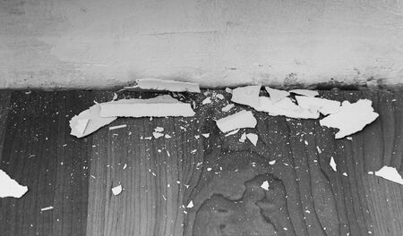 old plaster remains on the wooden floor in black and whiteの写真素材