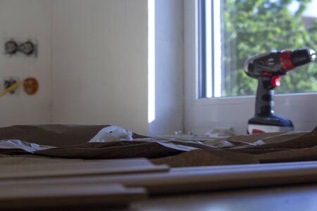 old paper remnants, which served as protection for the floor, looking towards the window on the battery screwの写真素材