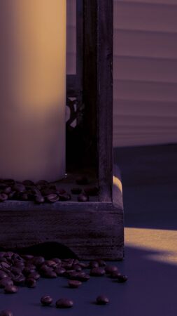 coffee beans trickling out of a wooden lantern, wrapped in evening sunshineの写真素材