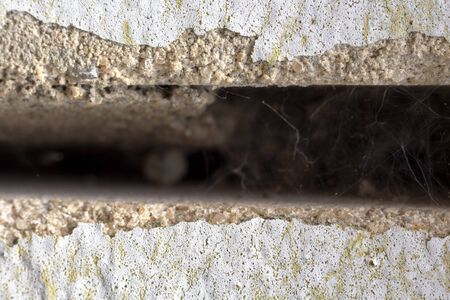 two sand-lime bricks in an old wall from which the cement is already fallingの写真素材