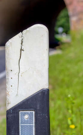 reflector of a defective road post, with long crackの写真素材