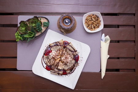 Sweet chocolate and fruit pancakes in romantic restaurantの写真素材