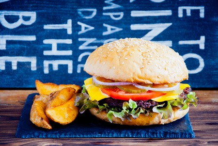 Homemade burger made from fresh vegetables and beef on wooden backgroundの写真素材