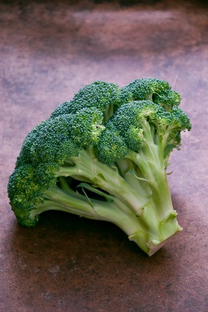 Fresh green broccoli on a brown wooden background