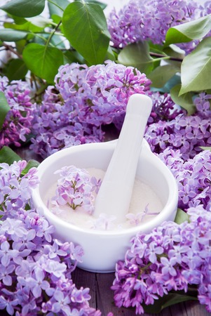 Lilac flowers and sugar on gray wooden backgroundの写真素材