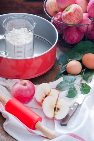 Making Homemade Apple Pie with flour, eggs and rolling pin redの写真素材