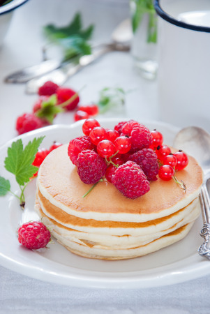 Homemade Pancakes with fresh red berries and honeyの写真素材
