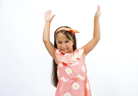 Adorable little girl smiling happily at the cameraの写真素材