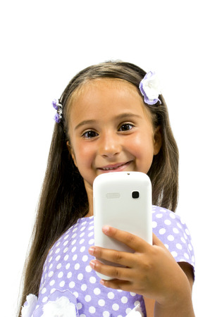 Beautiful girl smiling and holding a smartphoneの写真素材