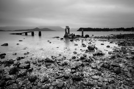 a desolate and broken peer on the beachの写真素材