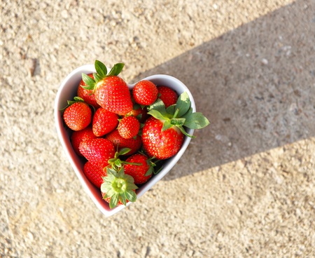 strawberries in heart shape bowlの写真素材