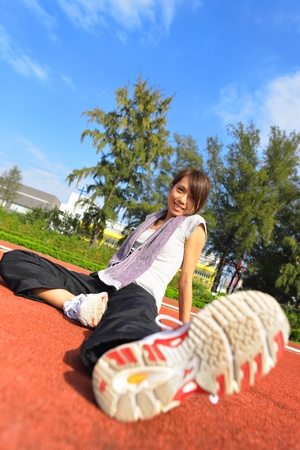 sport girl sitting in sport fieldの写真素材