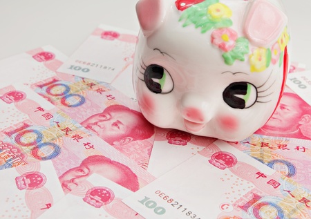 piggy bank on china banknoteの写真素材