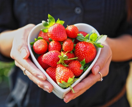 strawberry in heart shape bowlの写真素材
