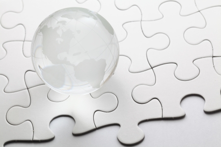 glass globe with puzzle backgroundの写真素材