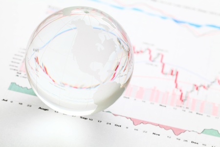 Glass earth ball on the financial chartの写真素材