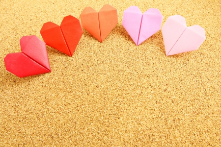 Origami colorful heart on corkboard の写真素材