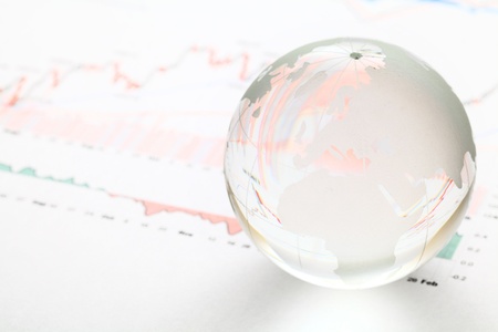 Glass earth ball on the financial chartの写真素材