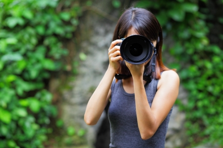 Asian woman taking photoの写真素材