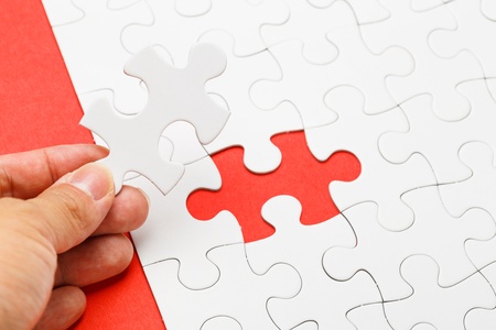 Incomplete puzzle with missing piece on human handの写真素材