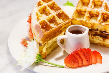 Waffles with syrup and strawberriesの写真素材