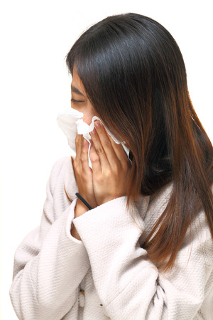 Sneezing asian womanの写真素材