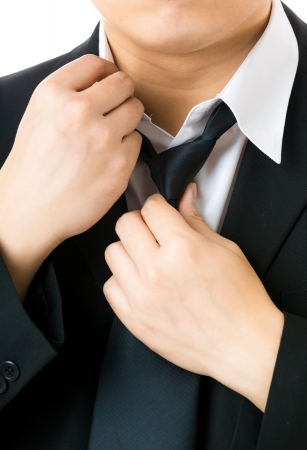Businessman adjusting tieの写真素材