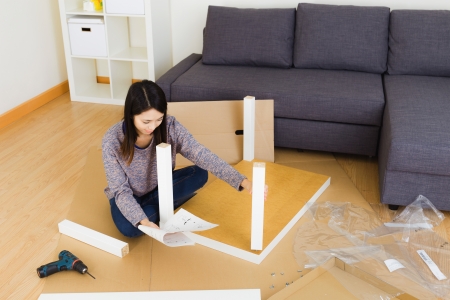 Woman assembling  furnitureの写真素材