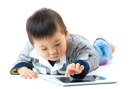 Asian little boy using digital tabletの写真素材