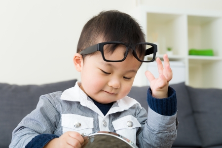 Asian boy wear glasses with mirrorの写真素材