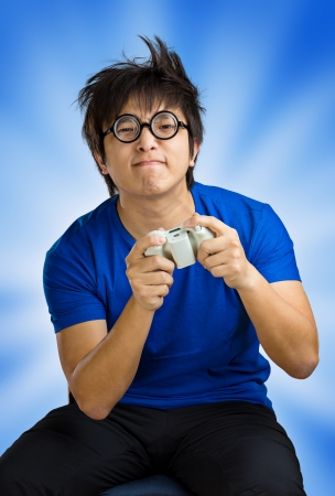 Man playing video game over blue backgroundの写真素材