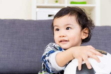 Asian baby boy holding soccer ballの写真素材