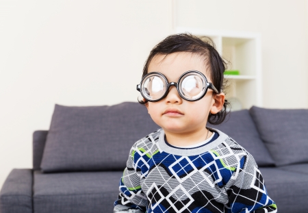 Little baby boy wear thick glassesの写真素材