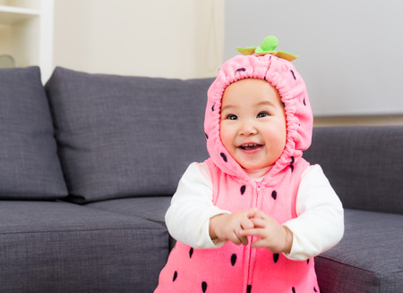 Baby with strawberry costumeの写真素材
