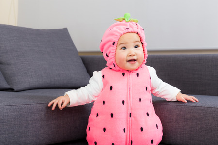 Asia baby with strawberry costumeの写真素材