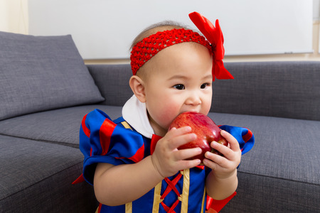 Little girl eat appleの写真素材