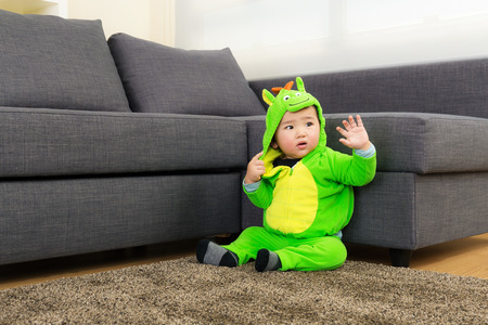 Baby with dinosaur halloween party costumeの写真素材