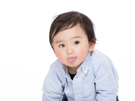 Asian baby making funny faceの写真素材