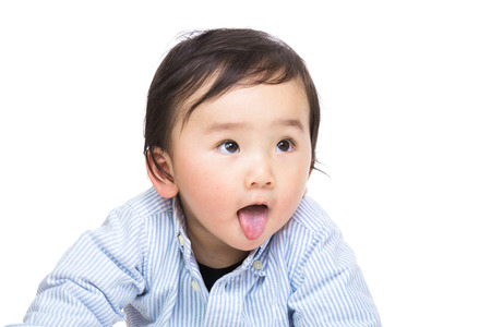 Asian baby showing tongueの写真素材
