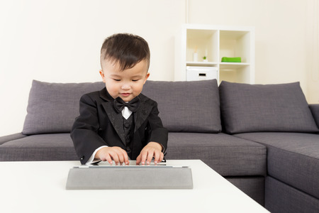 Toddler boy playing with digital tabletの写真素材