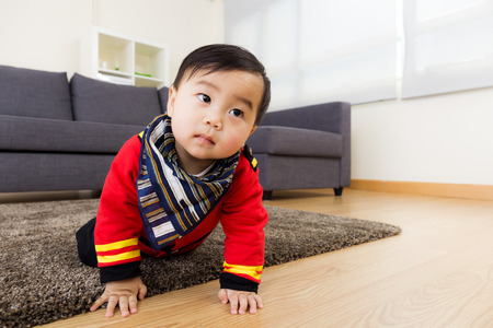 Asian baby boy creeping on floorの写真素材