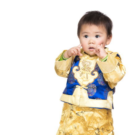 Asian baby boy with chinese costume and finger point to faceの写真素材