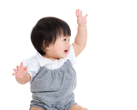 Asian baby girl greeting with hand upの写真素材