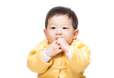 Chinese baby boy bite fingerの写真素材